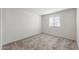 This bedroom features neutral carpet, a large window and light-colored walls at 2528 S 244Th Dr, Buckeye, AZ 85326