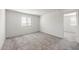 This bedroom features neutral carpet, a large window and light-colored walls at 2528 S 244Th Dr, Buckeye, AZ 85326