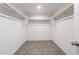 Walk-in closet with carpeted floor and open shelving for easy organization at 2528 S 244Th Dr, Buckeye, AZ 85326