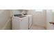 This laundry room features a white washer and dryer and white shelving at 2528 S 244Th Dr, Buckeye, AZ 85326