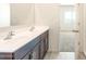 Bathroom with double vanity sinks, modern fixtures and dark cabinets at 2544 S 244Th Dr, Buckeye, AZ 85326