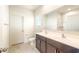 Bathroom with double sink vanity and bright lighting at 2544 S 244Th Dr, Buckeye, AZ 85326