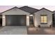 Charming single-story home with a two-car garage and low-maintenance desert landscaping at 2544 S 244Th Dr, Buckeye, AZ 85326