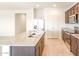 Well-lit kitchen with an island, stainless steel appliances, and tile flooring at 2544 S 244Th Dr, Buckeye, AZ 85326