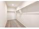 Walk-in closet includes carpet flooring, shelving and lighting at 2544 S 244Th Dr, Buckeye, AZ 85326