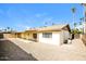 View of the home's backyard featuring gravel landscaping, covered patio, and tall palm trees at 2643 E Virginia Ave, Phoenix, AZ 85008