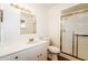 Clean bathroom with white vanity, toilet, and a glass-enclosed shower, offering a functional and modern space at 2643 E Virginia Ave, Phoenix, AZ 85008