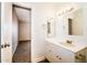 Bright bathroom featuring a vanity with sink and updated fixtures and a view to an adjoining room at 2643 E Virginia Ave, Phoenix, AZ 85008