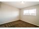 Serene bedroom with carpet and neutral walls, highlighted by a window that bathes the space in gentle, natural light at 2643 E Virginia Ave, Phoenix, AZ 85008