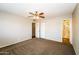 Spacious bedroom with neutral carpet and paint featuring an en suite bathroom and closet at 2643 E Virginia Ave, Phoenix, AZ 85008