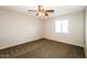 Cozy bedroom with neutral walls, plush carpeting, and a ceiling fan provides a comfortable living space at 2643 E Virginia Ave, Phoenix, AZ 85008