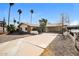 Attractive single-story home with a spacious driveway and desert landscaping under a clear blue sky at 2643 E Virginia Ave, Phoenix, AZ 85008