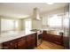 Well-lit kitchen featuring stainless steel appliances, a stylish range hood, and an island cooktop at 2643 E Virginia Ave, Phoenix, AZ 85008