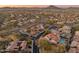 An aerial view of a neighborhood, showcasing a lush, green environment with mountain views in the distance at 30259 N 125Th Ln, Peoria, AZ 85383