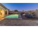 Beautiful backyard oasis with a sparkling pool, spa, fire pit, and comfortable lounge chairs at 30259 N 125Th Ln, Peoria, AZ 85383