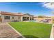 Expansive backyard featuring a pool, hot tub, green lawn, and lounging area, perfect for outdoor entertaining at 30259 N 125Th Ln, Peoria, AZ 85383