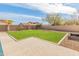 A well-maintained backyard with lush green grass surrounded by a brick perimeter, offering a private outdoor space at 30259 N 125Th Ln, Peoria, AZ 85383