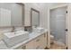 Farmhouse bathroom featuring double sinks, framed mirrors, and access to the walk-in shower at 30259 N 125Th Ln, Peoria, AZ 85383