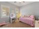 Bright bedroom with vanity and plush pink bedding and decorative pillows at 30259 N 125Th Ln, Peoria, AZ 85383