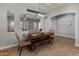 Charming dining area with rustic wooden table, bench seating, and modern pendant lighting at 30259 N 125Th Ln, Peoria, AZ 85383