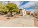 Charming home with a terracotta roof, stucco exterior, and a spacious driveway surrounded by desert landscaping at 30259 N 125Th Ln, Peoria, AZ 85383