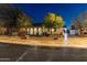 Inviting single-story home with a well-manicured front yard and charming facade at twilight at 30259 N 125Th Ln, Peoria, AZ 85383