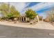 Inviting home with a terracotta roof, arched entryway, desert landscaping and a spacious driveway at 30259 N 125Th Ln, Peoria, AZ 85383