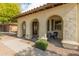 Inviting front porch with arched columns, elegant seating, and manicured landscaping at 30259 N 125Th Ln, Peoria, AZ 85383