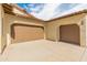 Spacious two-car garage featuring modern doors and ample parking space, surrounded by xeriscape landscaping at 30259 N 125Th Ln, Peoria, AZ 85383