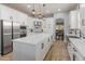 Bright kitchen with white cabinetry, stainless steel appliances, quartz countertops and pendant lighting at 30259 N 125Th Ln, Peoria, AZ 85383