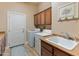 Functional laundry room with cabinets and countertop space, plus a large sink at 30259 N 125Th Ln, Peoria, AZ 85383