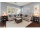 Cozy living room with plush sofas, soft lighting, and neutral tones, creating a relaxing atmosphere at 30259 N 125Th Ln, Peoria, AZ 85383