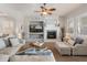 Cozy living room features a fireplace, a ceiling fan, and comfortable seating at 30259 N 125Th Ln, Peoria, AZ 85383