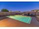 Backyard pool featuring a hot tub, fire pit, lounge chairs, and lush landscaping for outdoor enjoyment at 30259 N 125Th Ln, Peoria, AZ 85383