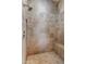 Walk-in shower featuring beautiful neutral tile and a built-in bench at 30259 N 125Th Ln, Peoria, AZ 85383