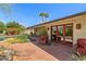 Inviting back patio with lush landscaping, lounge seating, and access to the pool for relaxing outdoor living at 318 E Concorda Dr, Tempe, AZ 85282