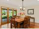 Dining room with wood floors, table with seating for six, slider doors to outside, and hanging light fixture at 318 E Concorda Dr, Tempe, AZ 85282