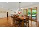 Open dining room with wood floors, table with seating for six, slider doors to outside, and view to living room at 318 E Concorda Dr, Tempe, AZ 85282