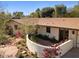 Charming home featuring a private walled patio, landscaped yard, and beautiful desert flowers at 318 E Concorda Dr, Tempe, AZ 85282