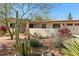 Single-story home with desert landscaping, cacti, and a red front door at 318 E Concorda Dr, Tempe, AZ 85282