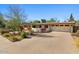 Single-story home with desert landscaping, a wide driveway and a red front door at 318 E Concorda Dr, Tempe, AZ 85282