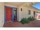 Inviting front porch with blue trimmed door, red accents, and manicured greenery at 318 E Concorda Dr, Tempe, AZ 85282