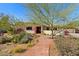 Charming single-story home with desert landscaping, a stone walkway, and a vibrant red front door at 318 E Concorda Dr, Tempe, AZ 85282