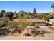 This single-story residence has a large front yard, desert-friendly landscaping, and a broad driveway that leads to a two-car garage at 318 E Concorda Dr, Tempe, AZ 85282