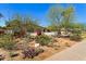 Single-story home with desert landscaping, a stone walkway, and a vibrant red front door at 318 E Concorda Dr, Tempe, AZ 85282