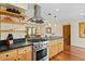 Bright kitchen featuring a center island, stainless steel appliances, and hardwood floors at 318 E Concorda Dr, Tempe, AZ 85282