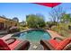 Scenic backyard pool with a red umbrella offering a great place to relax and enjoy sunny days at 318 E Concorda Dr, Tempe, AZ 85282