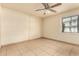 Bedroom featuring a ceiling fan and tile flooring with natural light at 3313 N 68Th St # 111, Scottsdale, AZ 85251