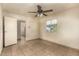 Bright bedroom with a large window, ceiling fan, and tile flooring at 3313 N 68Th St # 111, Scottsdale, AZ 85251