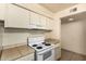 Kitchen featuring white appliances and a tile countertop breakfast bar, ideal for casual dining at 3313 N 68Th St # 111, Scottsdale, AZ 85251